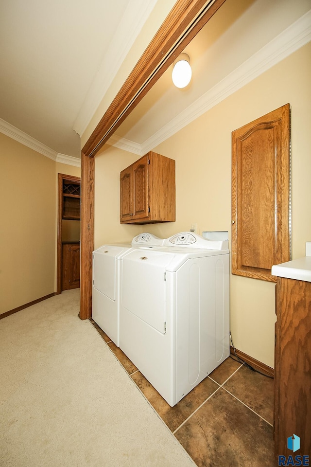 laundry area with cabinets, independent washer and dryer, dark colored carpet, and crown molding