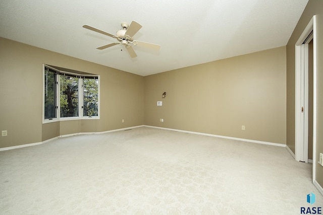 unfurnished bedroom featuring ceiling fan, light carpet, and a textured ceiling