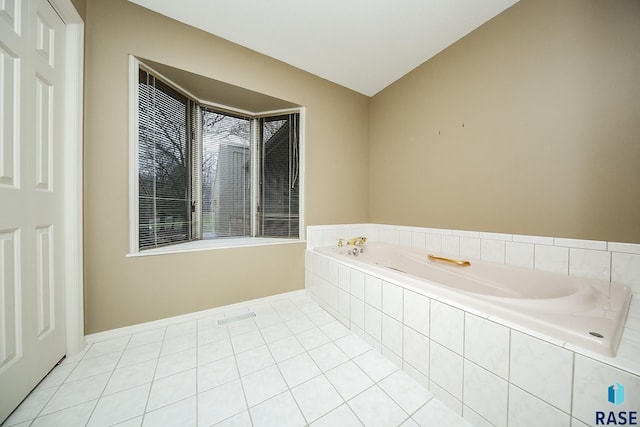 bathroom featuring a relaxing tiled tub and tile patterned floors