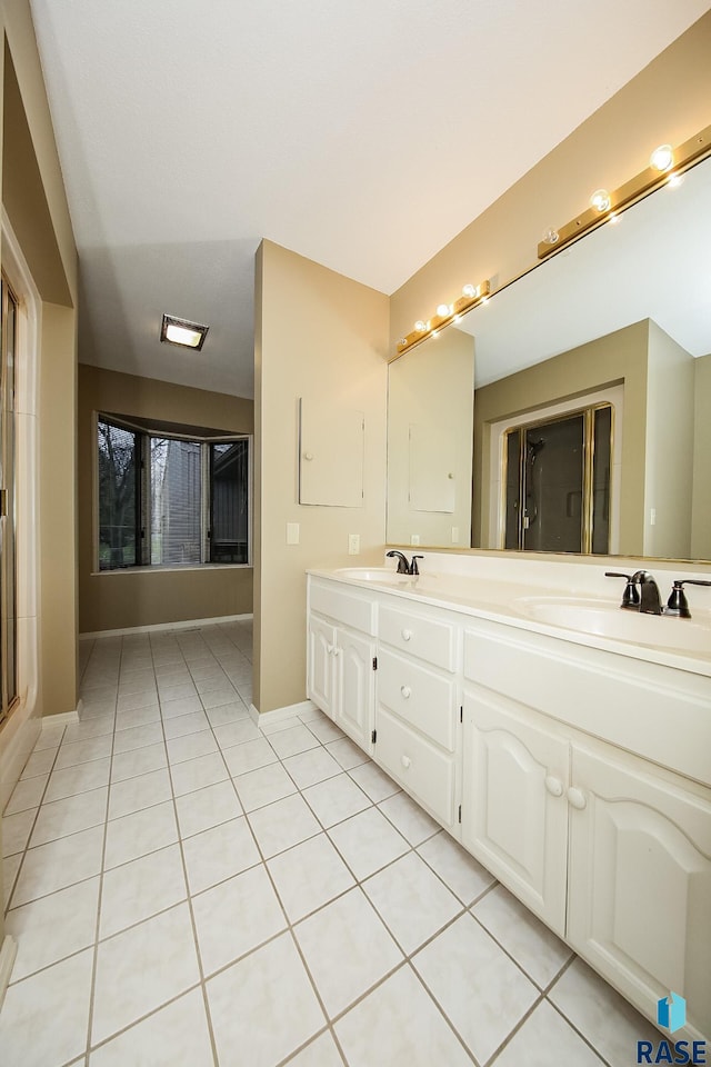 bathroom with tile patterned flooring and vanity