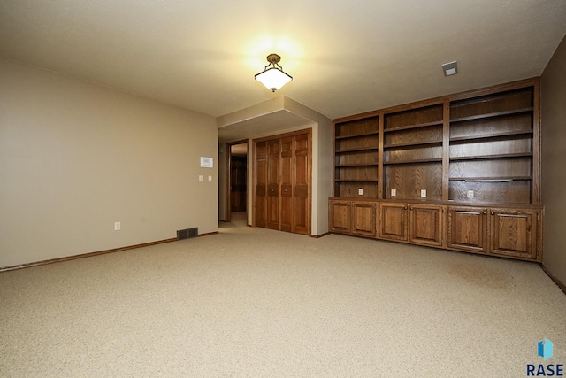 unfurnished living room featuring light colored carpet