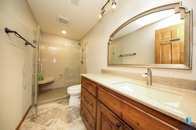 bathroom with vanity, an enclosed shower, and toilet