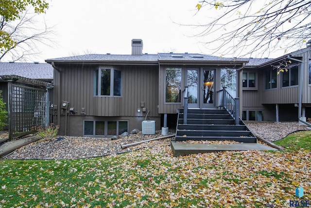 back of property with a sunroom and french doors