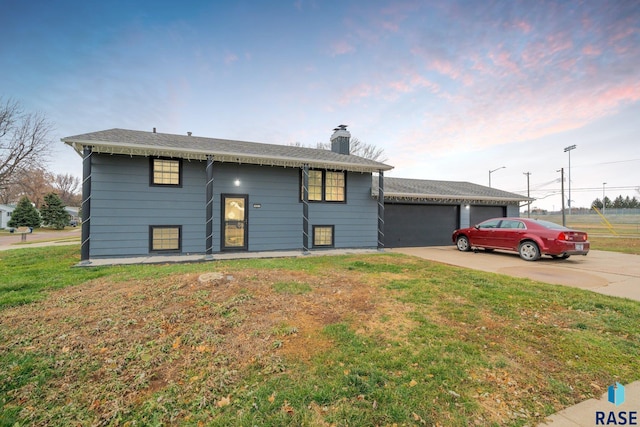 split foyer home with a front yard and a garage