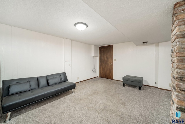 unfurnished room with light colored carpet and a textured ceiling