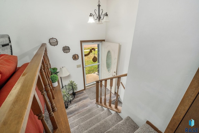 stairway featuring a chandelier and hardwood / wood-style floors