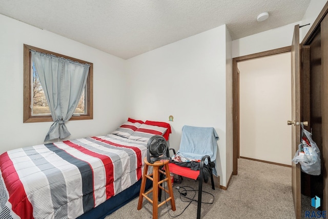 carpeted bedroom with a textured ceiling