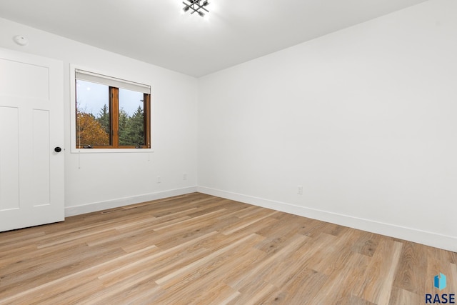 spare room with light hardwood / wood-style flooring