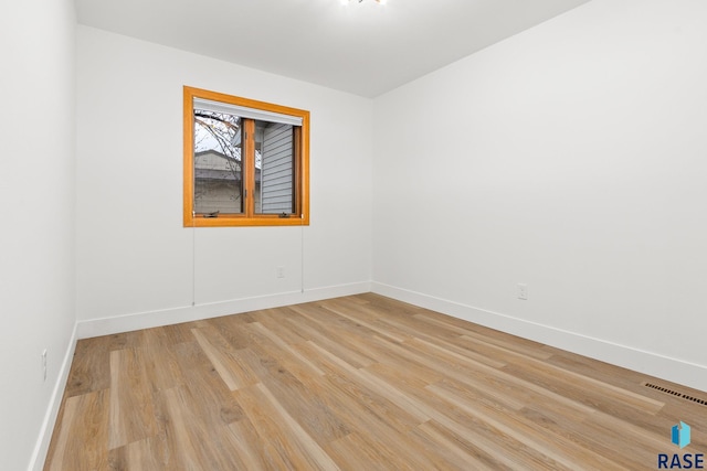 spare room featuring light hardwood / wood-style flooring