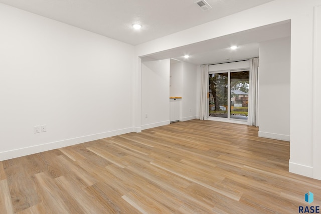 empty room with light hardwood / wood-style floors