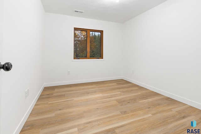 empty room with light hardwood / wood-style floors