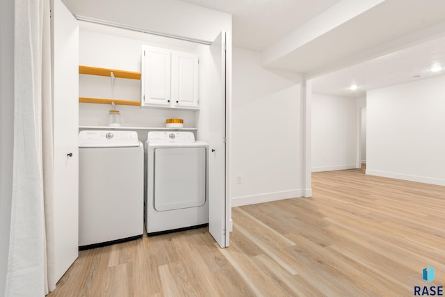 clothes washing area featuring light hardwood / wood-style floors and washing machine and clothes dryer