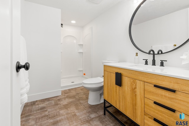 bathroom with vanity, toilet, and walk in shower