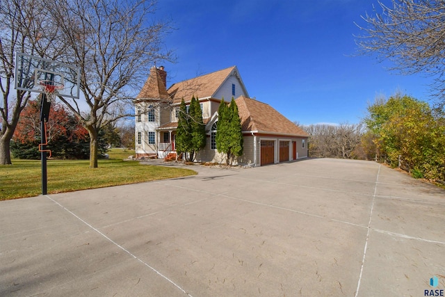 view of property exterior featuring a lawn and a garage