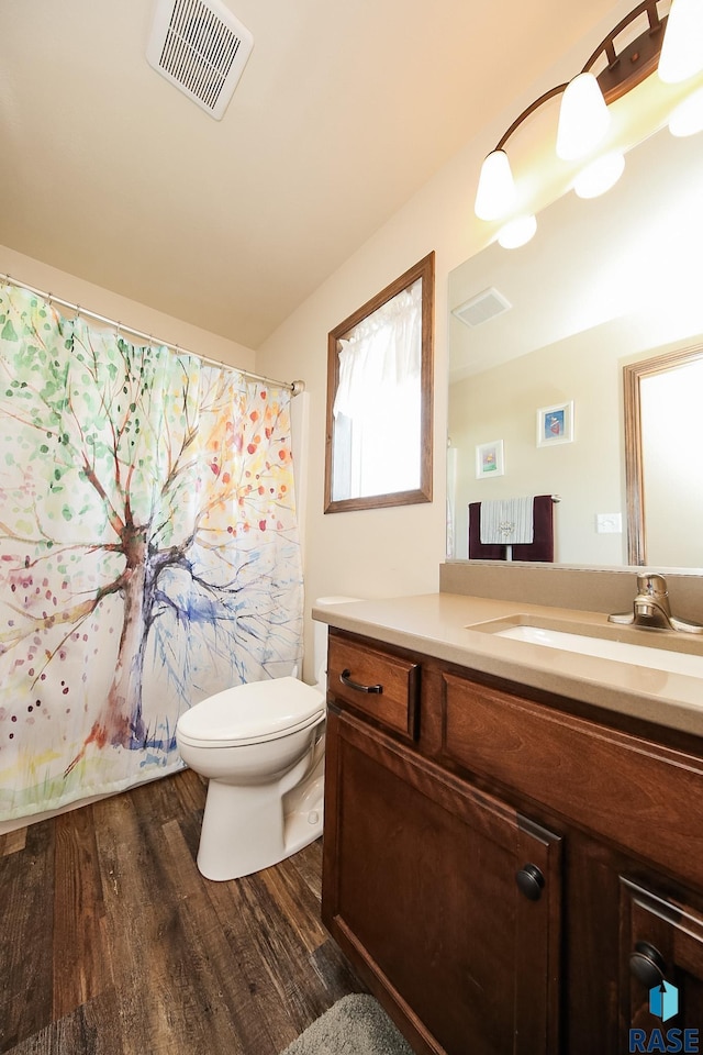 bathroom featuring hardwood / wood-style floors, vanity, and toilet