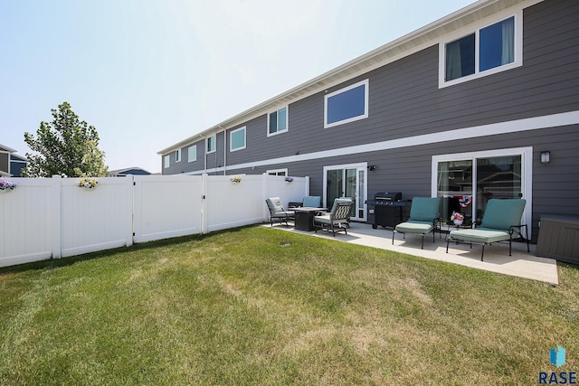 back of property with a yard and a patio area