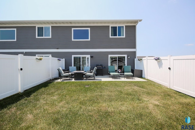 back of house featuring a yard and a patio