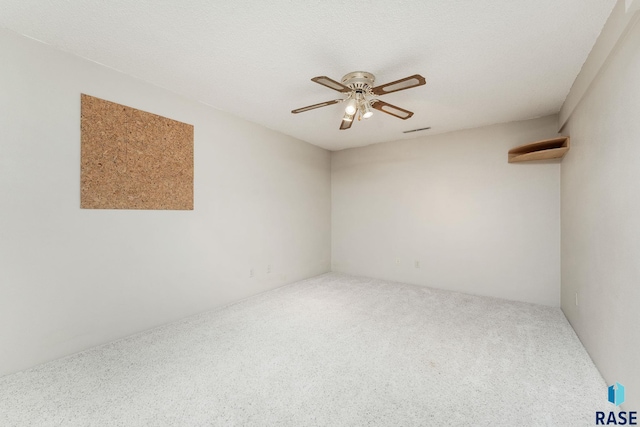 unfurnished room with a textured ceiling, carpet floors, and ceiling fan