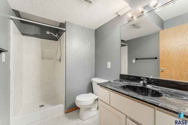 bathroom featuring a shower, a textured ceiling, and toilet