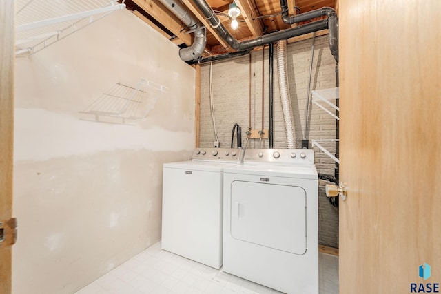 clothes washing area featuring independent washer and dryer