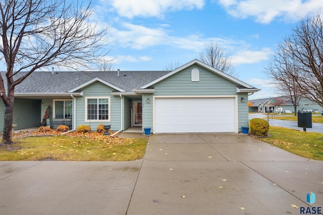 ranch-style house featuring a front lawn and a garage