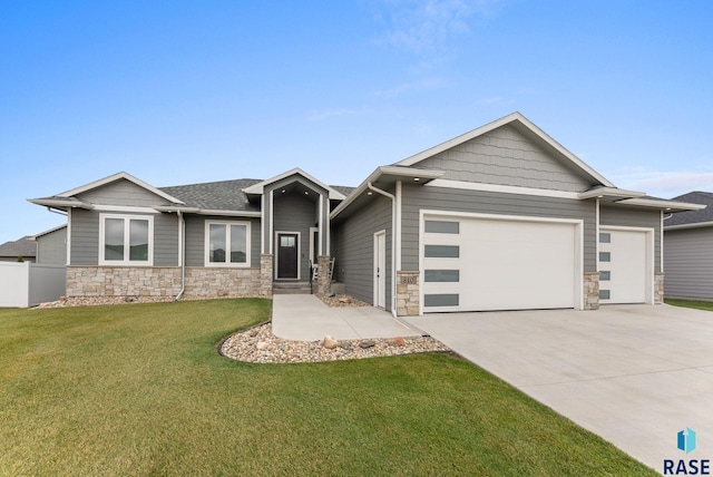 view of front facade with a front yard and a garage