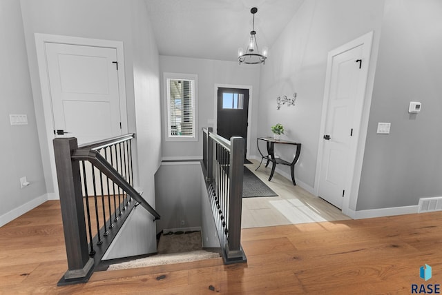 foyer with a chandelier and light hardwood / wood-style flooring