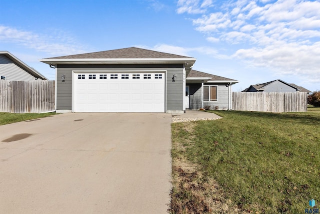 ranch-style home with a garage and a front yard