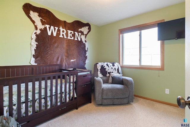 bedroom with carpet and a nursery area