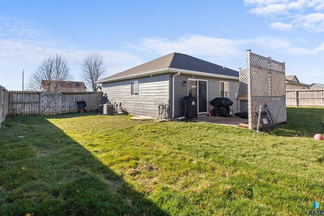 rear view of house featuring a yard and a patio