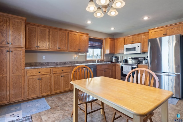 kitchen with sink, a chandelier, and appliances with stainless steel finishes