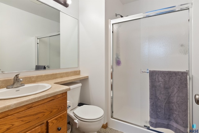 bathroom with tile patterned floors, vanity, and walk in shower