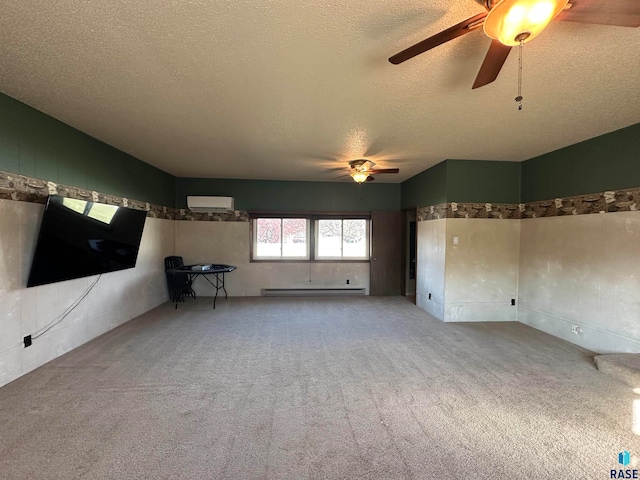 empty room featuring ceiling fan, light colored carpet, a textured ceiling, and a baseboard heating unit