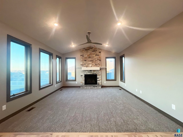 unfurnished living room featuring ceiling fan, carpet flooring, vaulted ceiling, and a fireplace