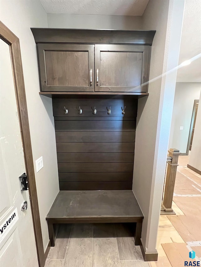 mudroom featuring a textured ceiling