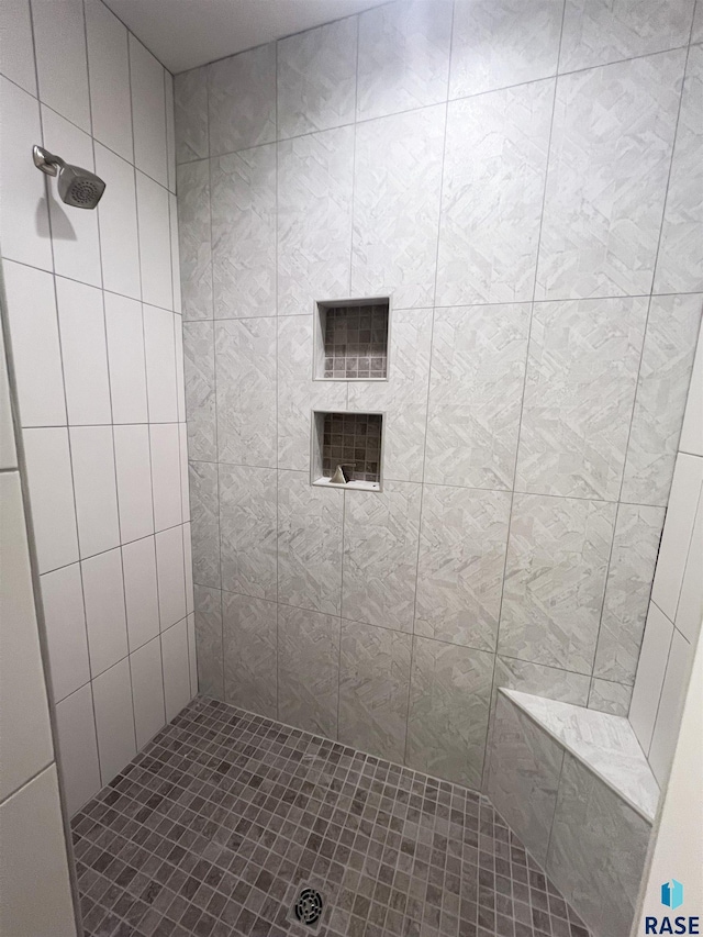 bathroom with a tile shower