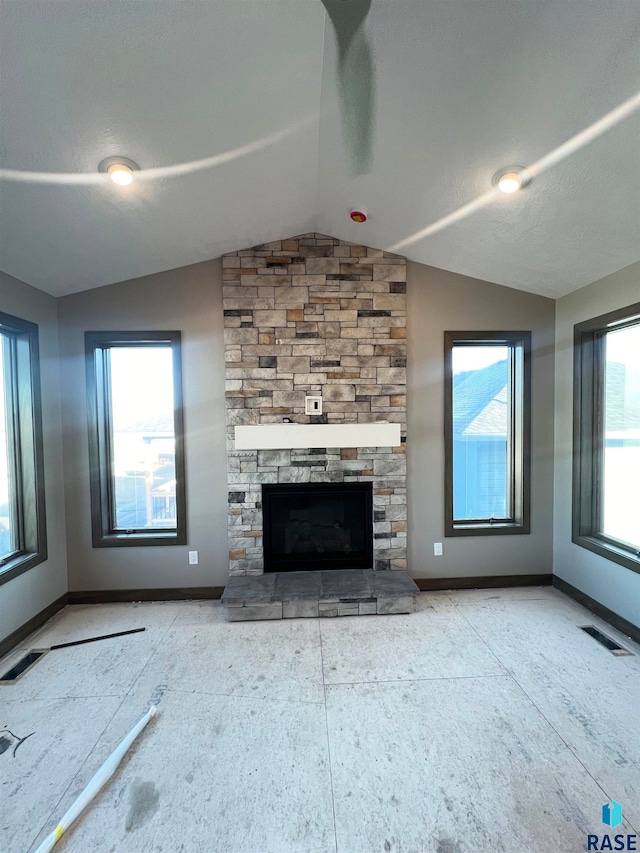 unfurnished living room with a fireplace and vaulted ceiling