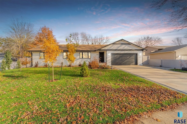 ranch-style house with a lawn and a garage