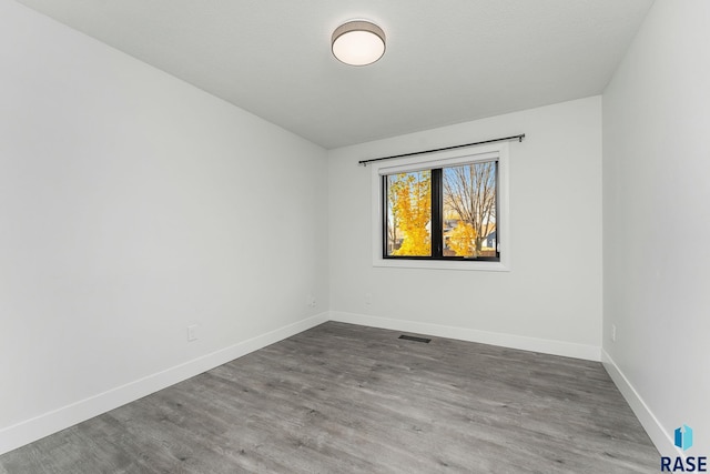 unfurnished room with hardwood / wood-style floors