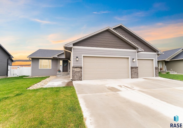 view of front facade with a lawn and a garage