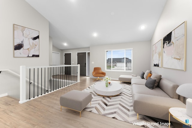 living room featuring light hardwood / wood-style floors and lofted ceiling