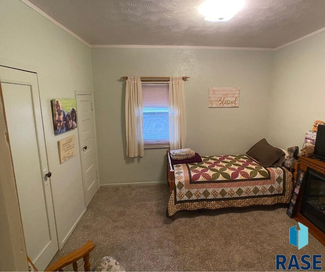 bedroom with carpet, a textured ceiling, and ornamental molding