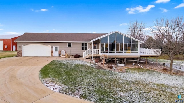 view of front facade with a sunroom, a deck, and a garage