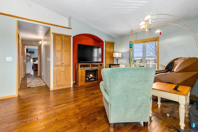 living room with dark hardwood / wood-style floors and lofted ceiling