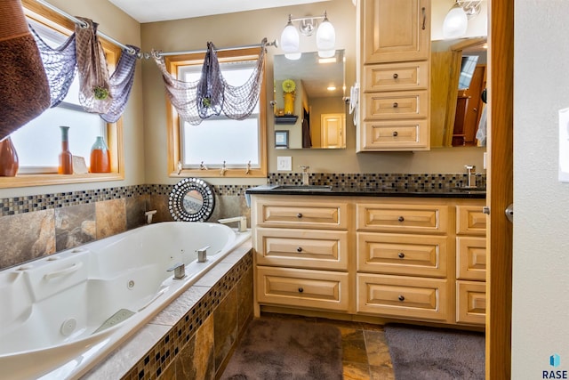 bathroom with vanity and a relaxing tiled tub