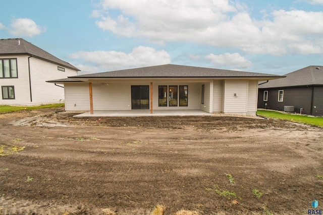 back of property with cooling unit and a patio