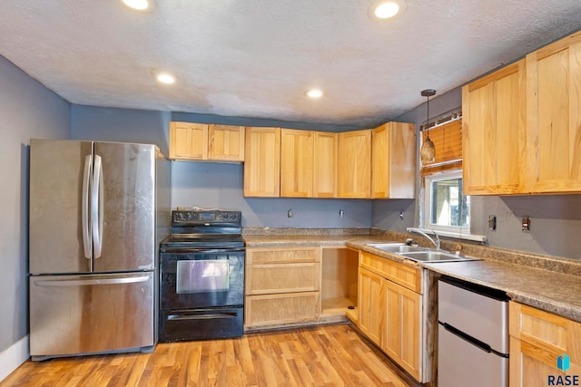 kitchen featuring stainless steel refrigerator, black range with electric cooktop, a textured ceiling, decorative light fixtures, and light wood-type flooring