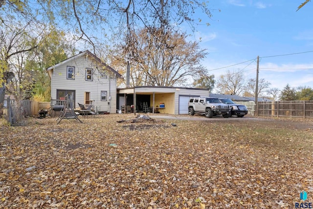 rear view of property with a garage