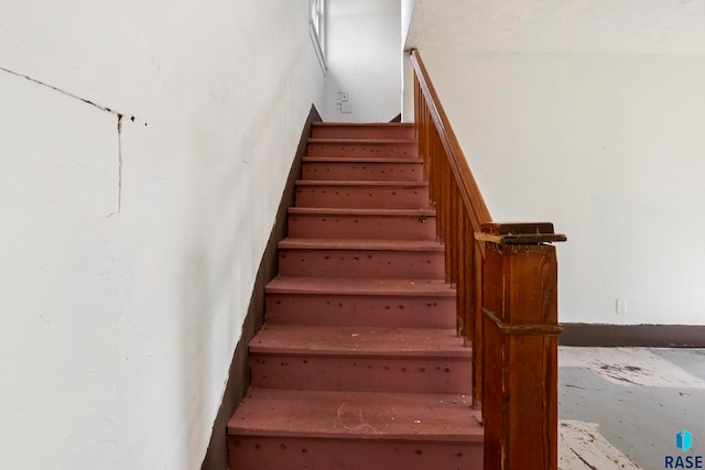 stairway featuring concrete flooring