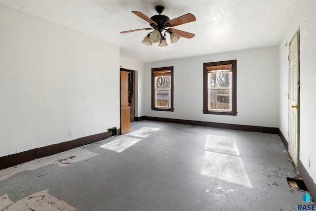 spare room featuring a textured ceiling and ceiling fan